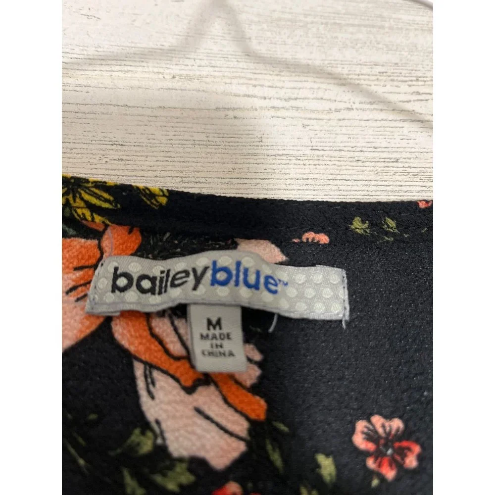 Bailey Blue woman’s v-neck black floral shirt sleeved one piece size medium.